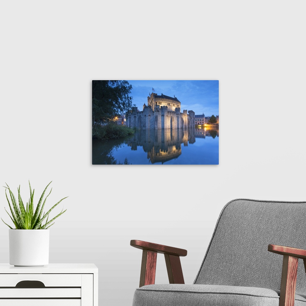 A modern room featuring Gravensteen (Castle of the Counts) at dusk, Ghent, Flanders, Belgium.
