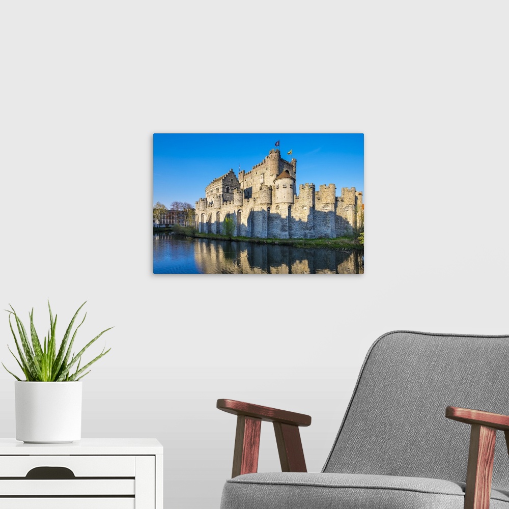 A modern room featuring Belgium, Flanders, Ghent (Gent). Gravensteen castle, 12th century medieval castle on the Leie River.