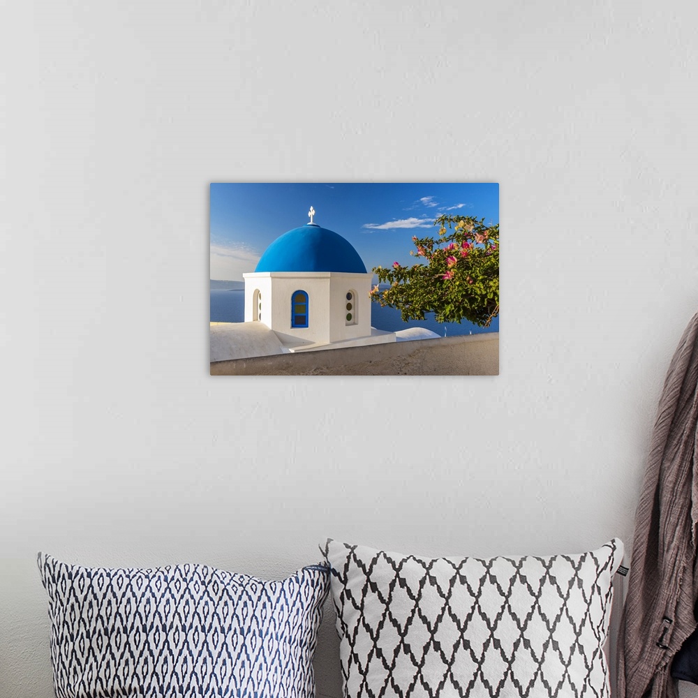 A bohemian room featuring Greek orthodox church with blue dome, Oia, Santorini, South Aegean, Greece
