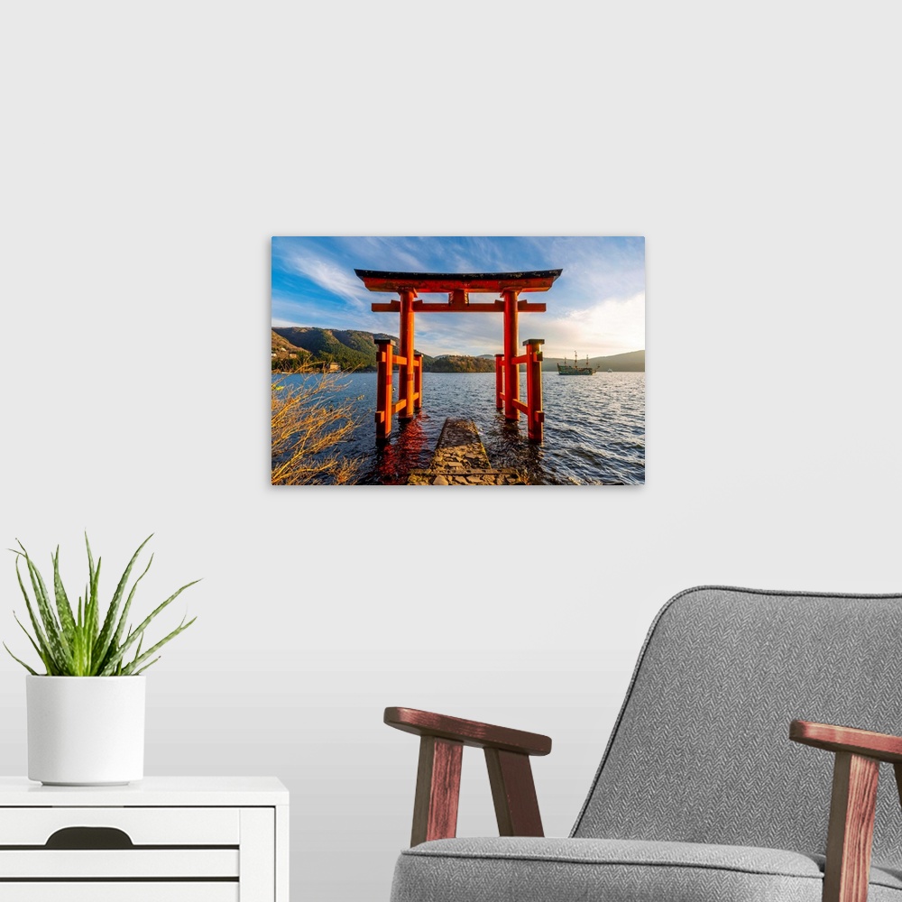 A modern room featuring Hakone, Kanagawa Prefecture, Honshu, Japan. Red torii gate at lake Ashi.