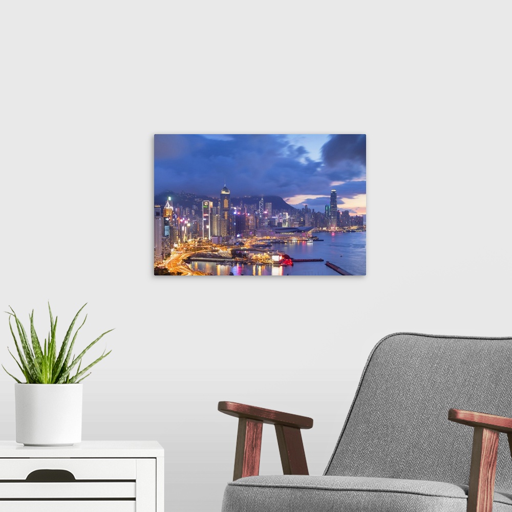 A modern room featuring Hong Kong Island skyline at sunset, Hong Kong.