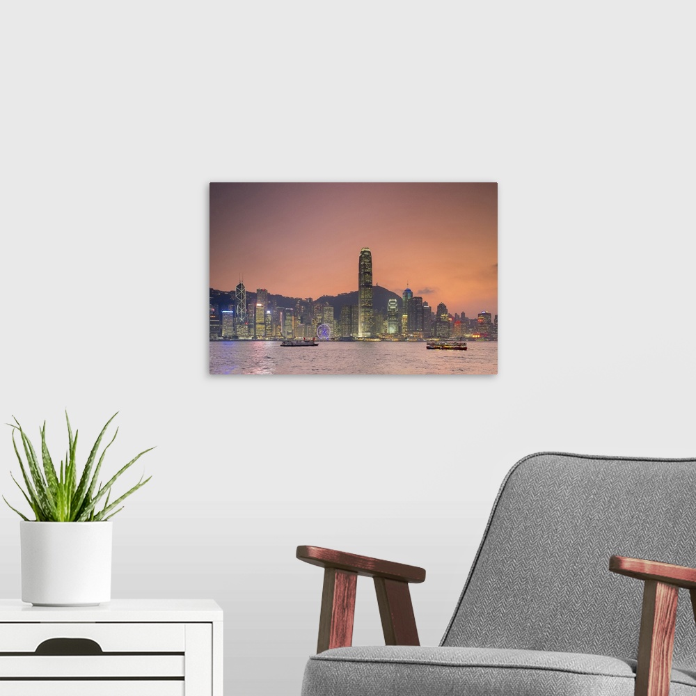 A modern room featuring Hong Kong skyline, skyscrapers on Hong Kong Island seen from Tsim Sha Tsui at sunset, Hong Kong, ...