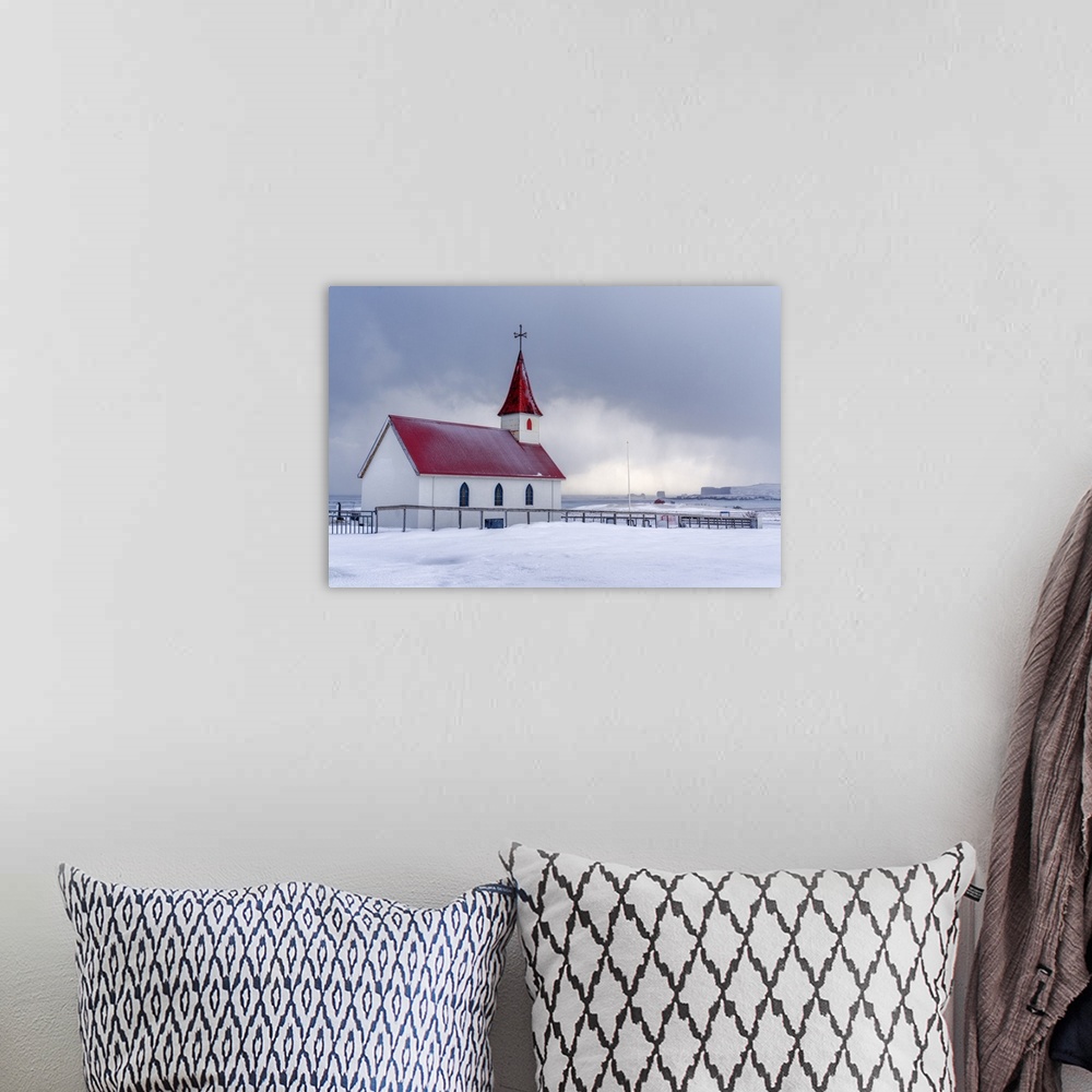 A bohemian room featuring Iceland: the little church of Reynisfjara looking at the storm on the seashore