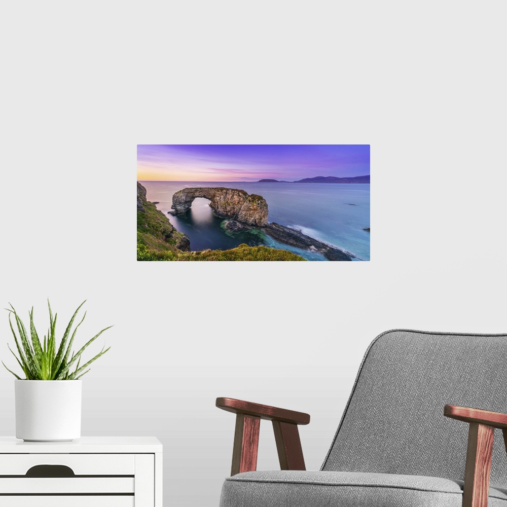 A modern room featuring Ireland, Co.Donegal, Fanad, Great Pollet sea arch at dusk