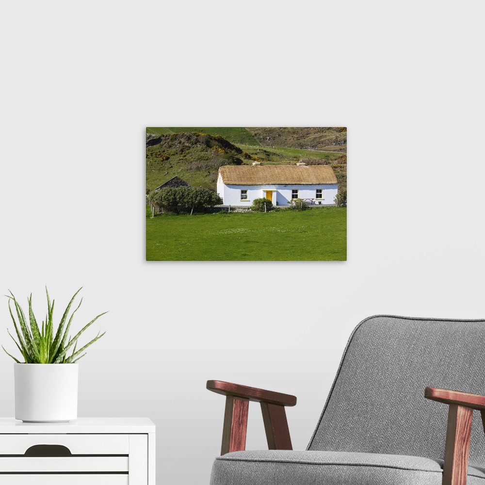 A modern room featuring Ireland, County Donegal, Glengesh Pass, landscape with traditional house.