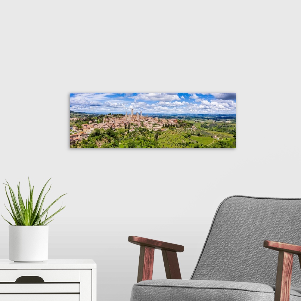 A modern room featuring Italy, Tuscany, Val d'Elsa. Panoramic aerial view of the medieval village of San Gimignano, a UNE...