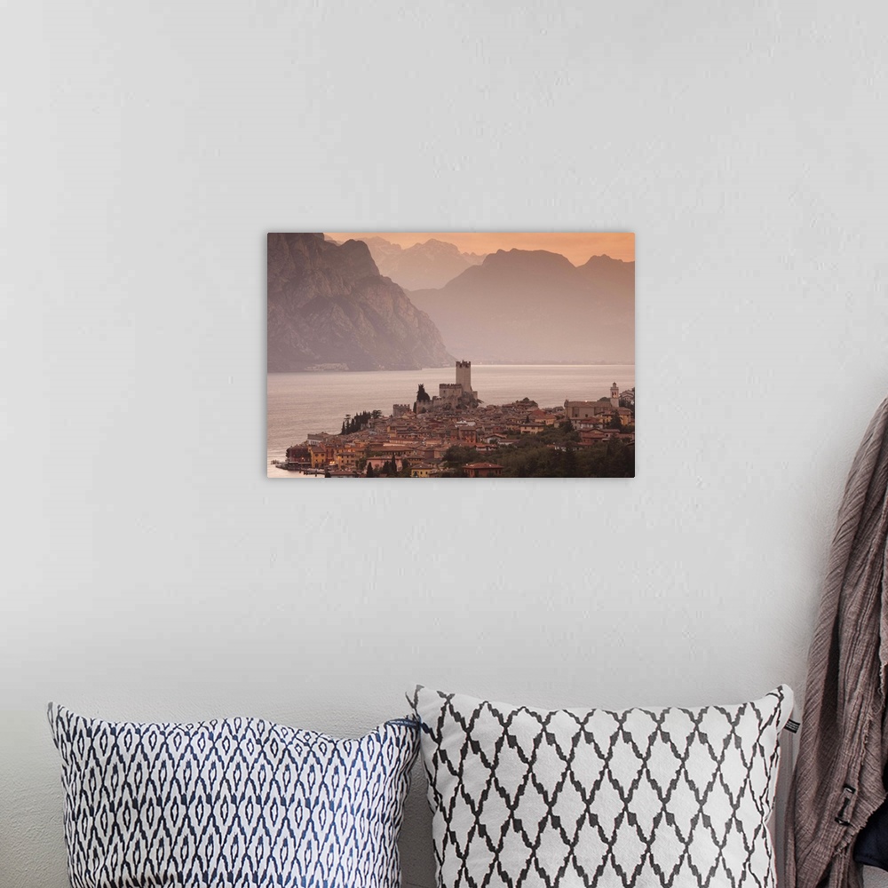 A bohemian room featuring Italy, Veneto, Lake District, Lake Garda, Malcesine, aerial town view, dawn