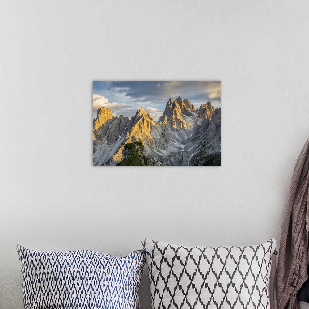 A bohemian room featuring Italy,Veneto,Belluno district,Auronzo di Cadore,sunset over the many spiers that shape the Cadini...