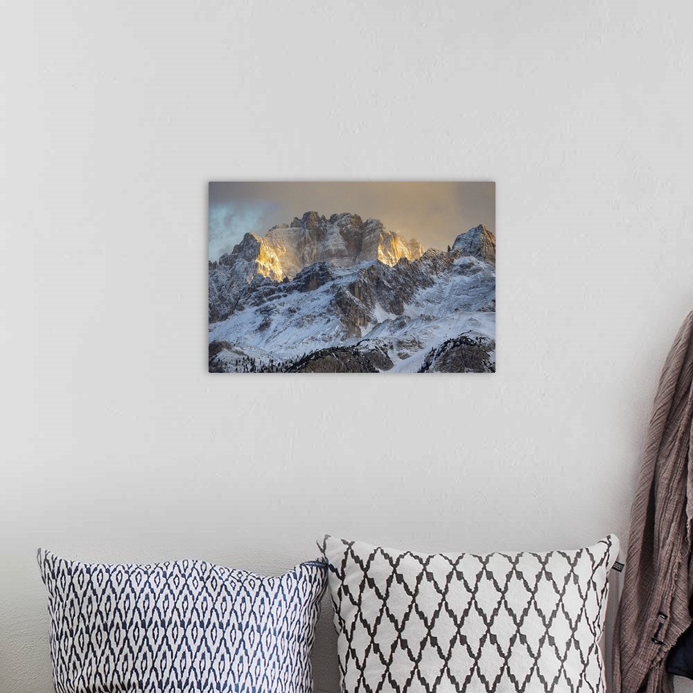 A bohemian room featuring Italy, Veneto, Belluno district, Cortina d'Ampezzo, the last rays of sun light up the walls of mo...