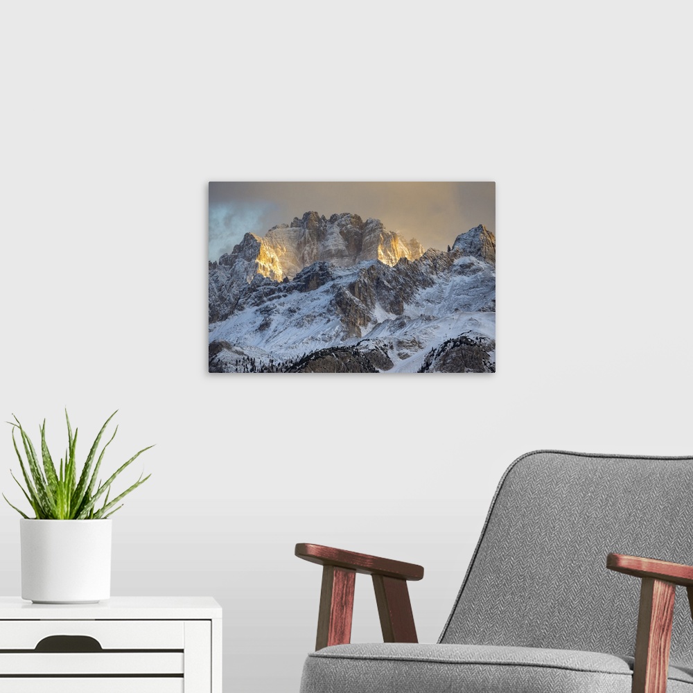 A modern room featuring Italy, Veneto, Belluno district, Cortina d'Ampezzo, the last rays of sun light up the walls of mo...