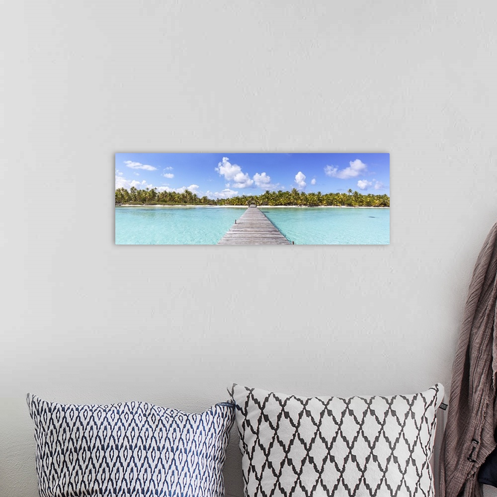 A bohemian room featuring Jetty to tropical island, Tikehau atoll, Tuamotus, French Polynesia.