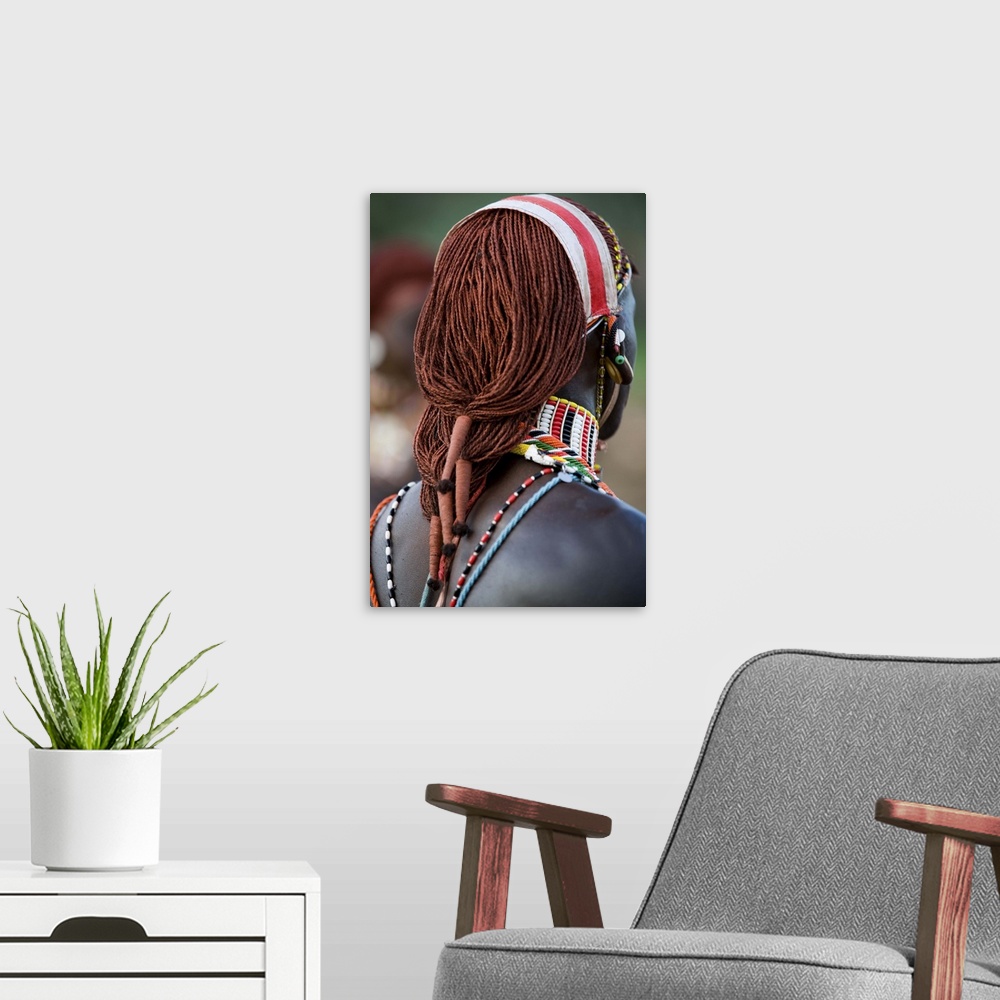 A modern room featuring Kenya, Laikipia, Ol Malo. A Samburu warrior's hair is ochred and tied up in braids at a dance at ...