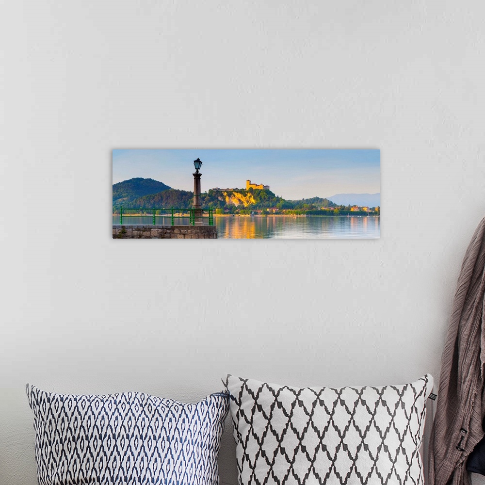 A bohemian room featuring The imposing La Rocca fortress viewd from Arona at sunset, Lake Maggiore, Piedmont, Italy.