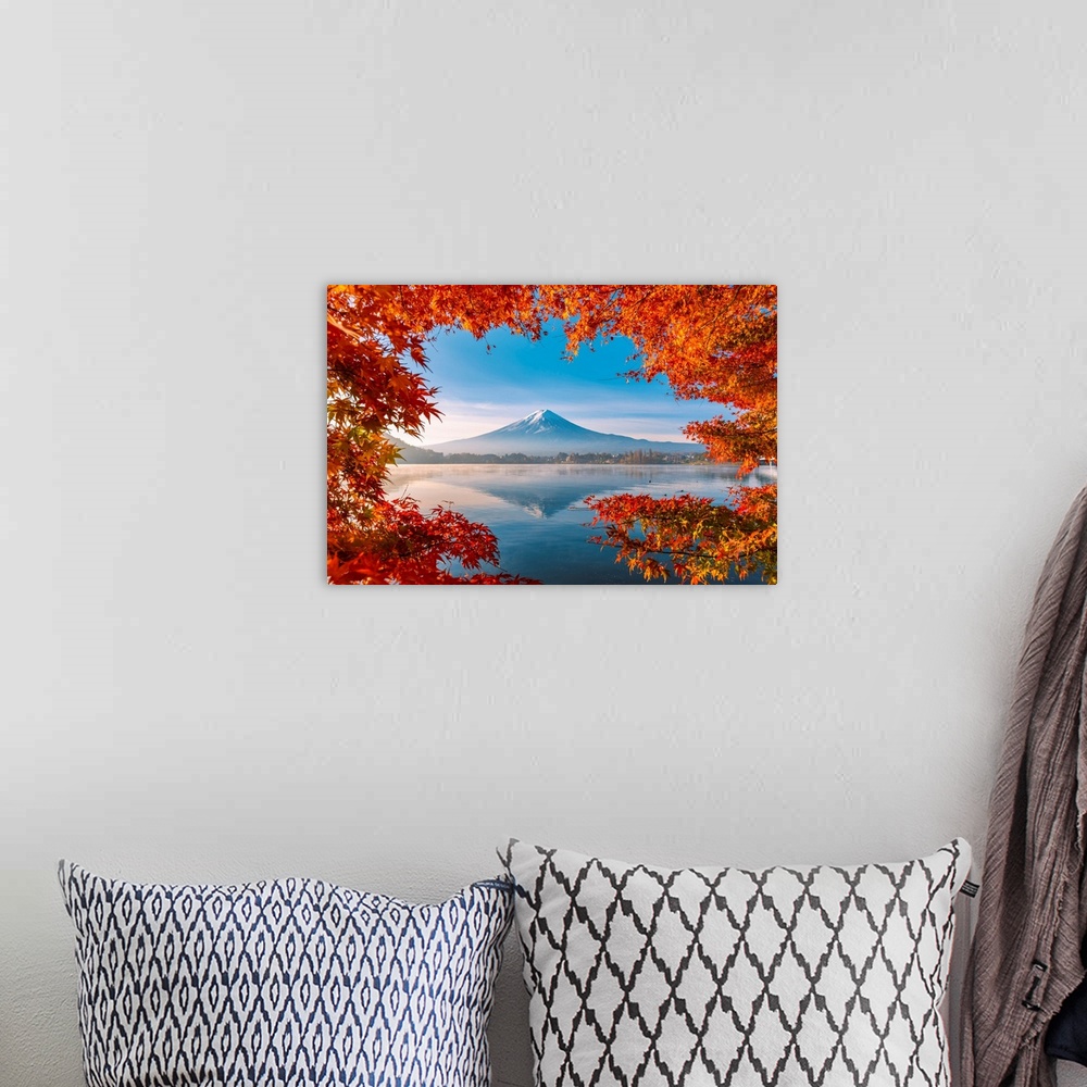 A bohemian room featuring Lake Kawaguchi and Mt Fuji framed by red maple leaves in autumn, Yamanashi Prefecture, Japan.