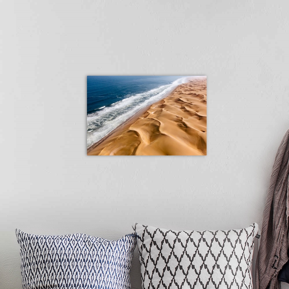 A bohemian room featuring Langewand, Aerial view of where the Atlantic Ocean meets the sea of dunes in Western Namibia.