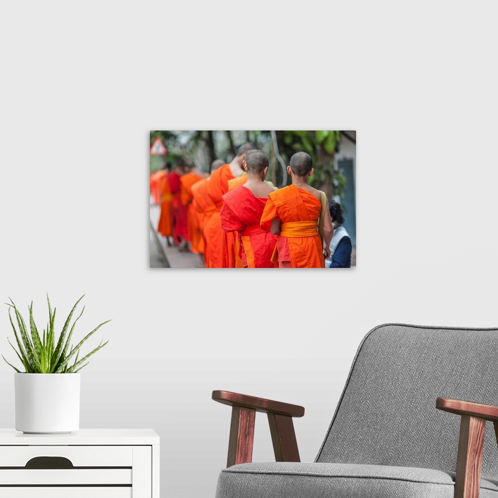 A modern room featuring Laos, Luang Prabang, Tak Bat, dawn procession of Buddhist monks collecting alms.