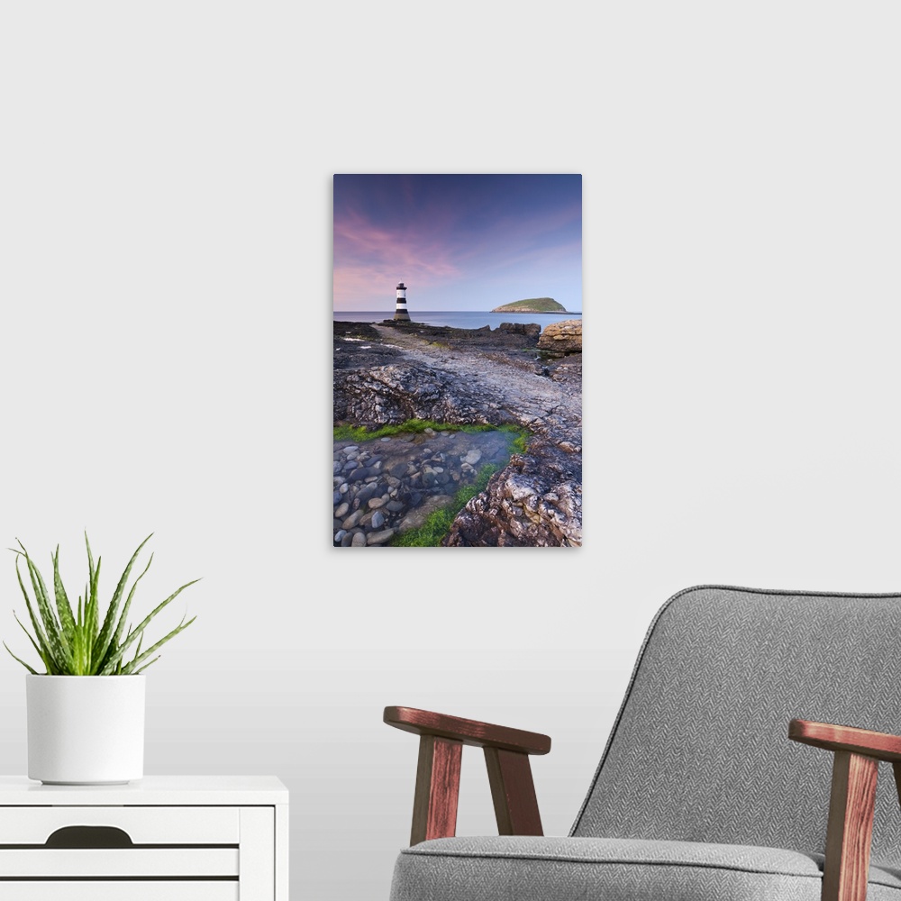 A modern room featuring Twilight on the rocky Anglesey coast looking towards Penmon Point Lighthouse and Puffin Island, A...
