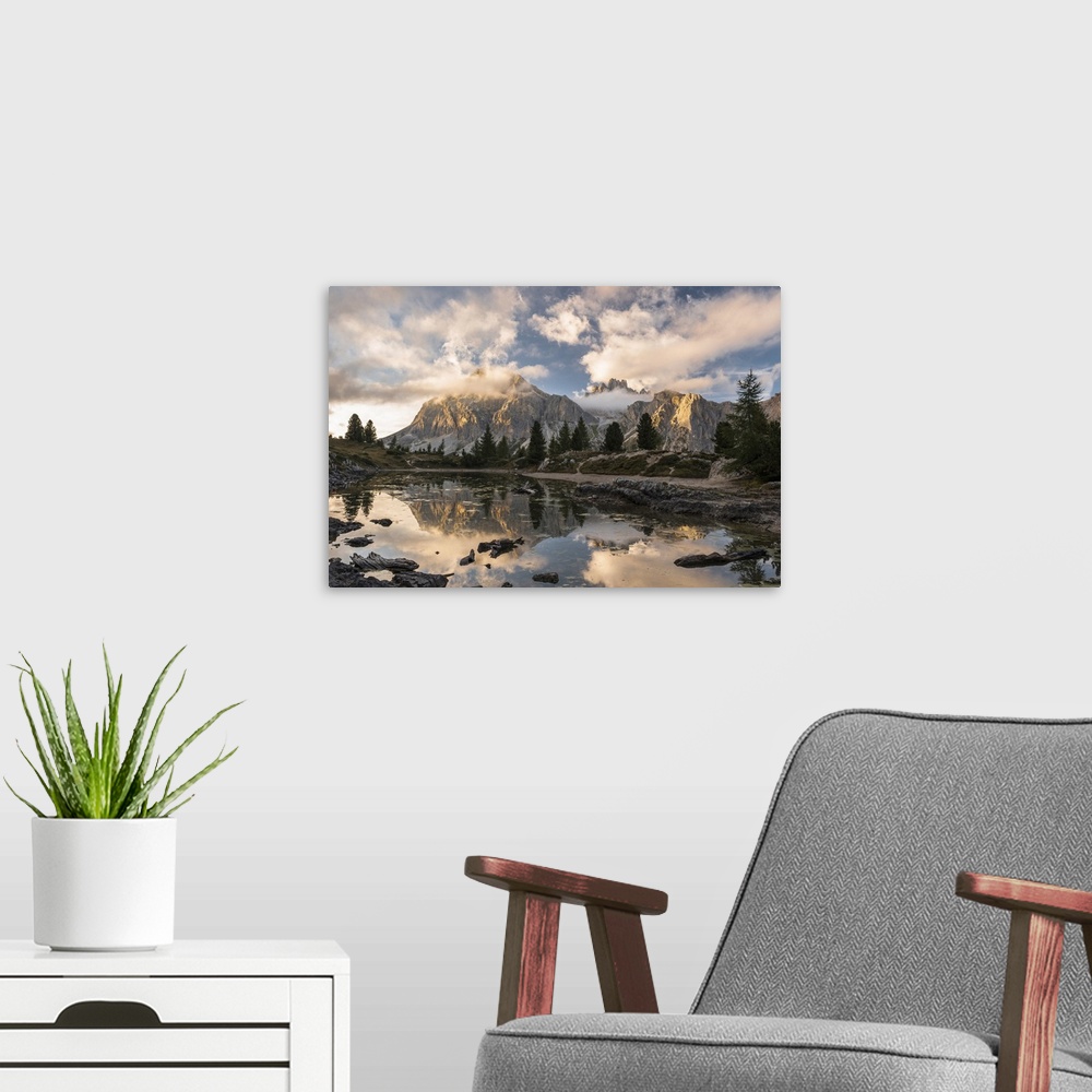 A modern room featuring Limides Lake at sunset with Lagazuoi on the background. Belluno, Veneto, Italy.