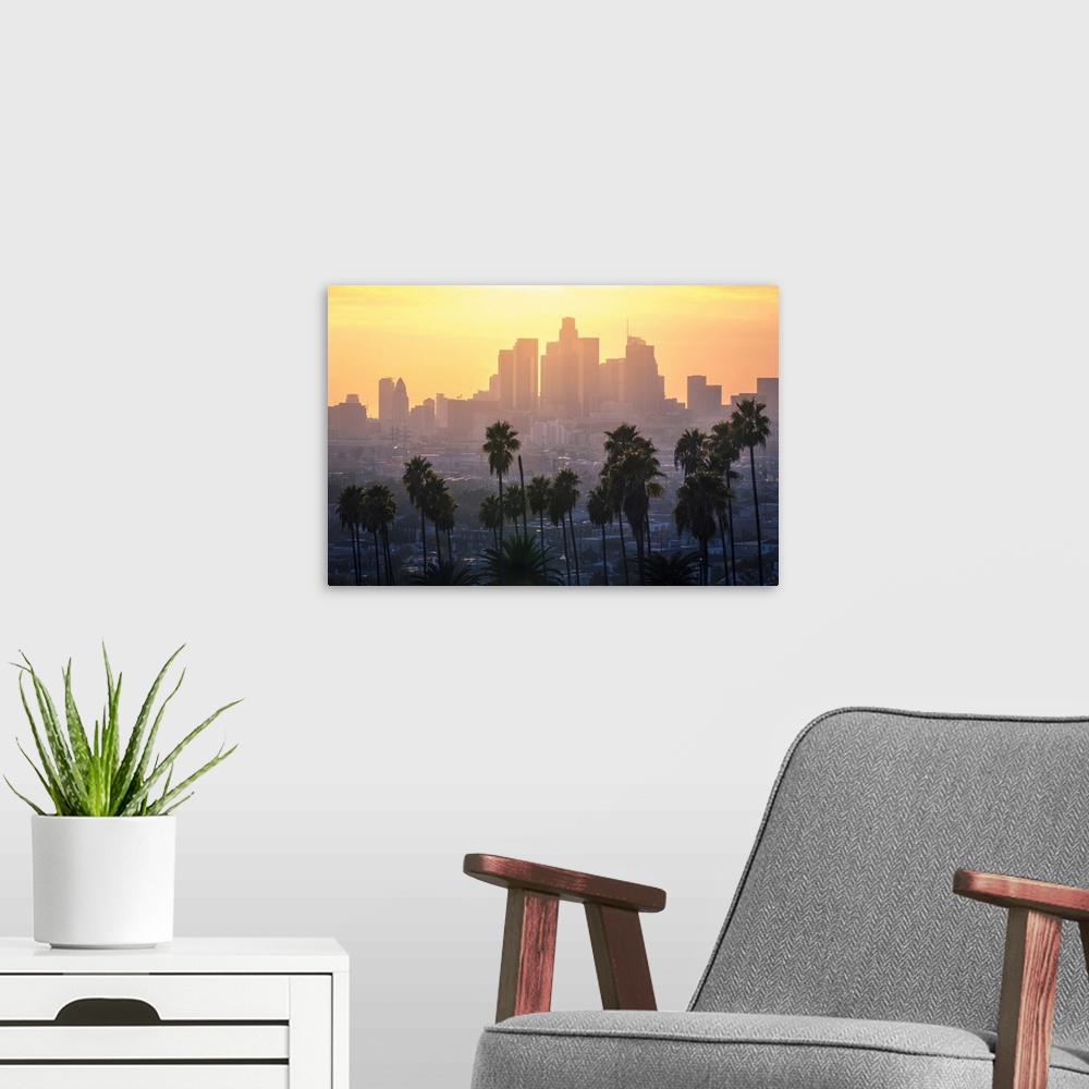 A modern room featuring Los Angeles Downtown and palm trees at sunset. This is a classic view of the city of angels, with...