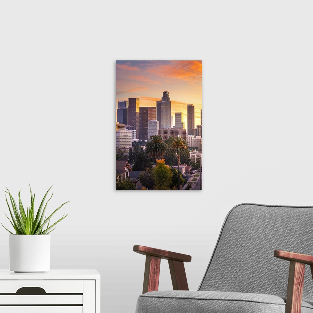 A modern room featuring Los Angeles Downtown at sunset as seen from Figueroa district. Los Angeles, California, USA
