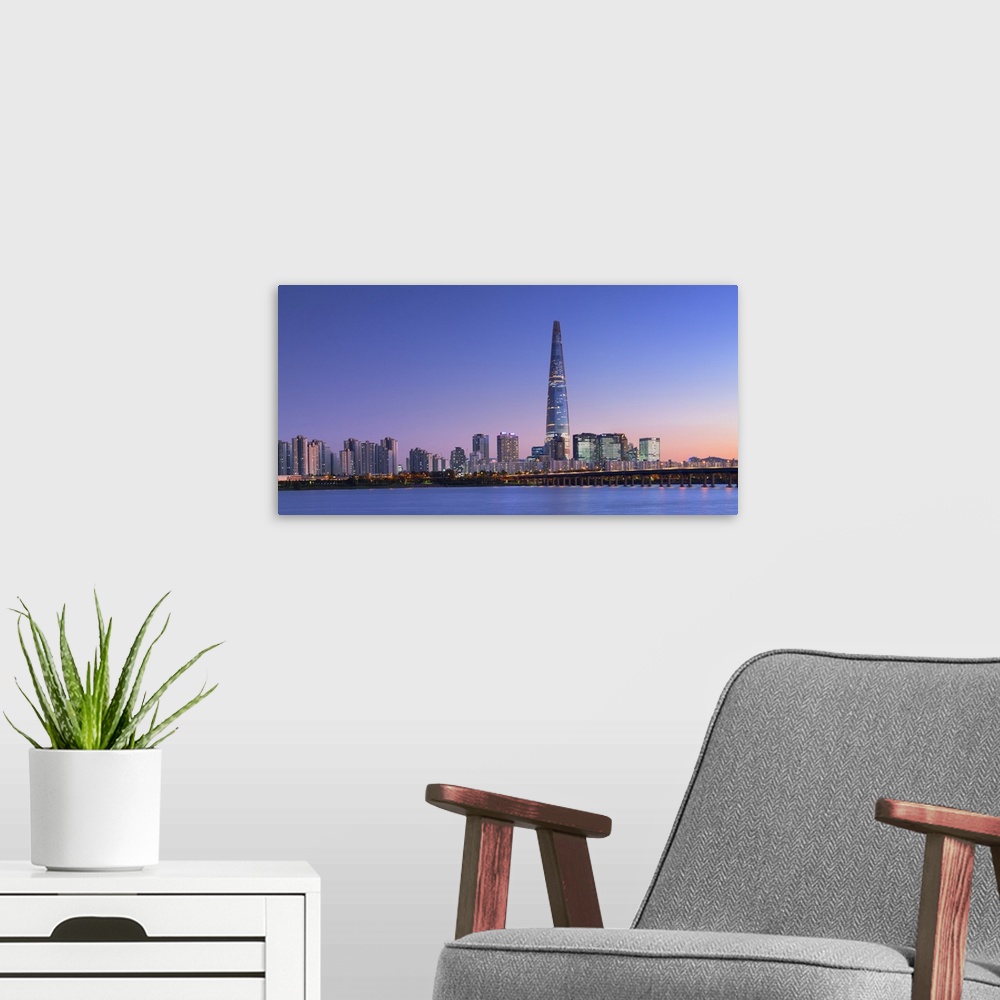 A modern room featuring Lotte World Tower and Han River at dusk, Seoul, South Korea