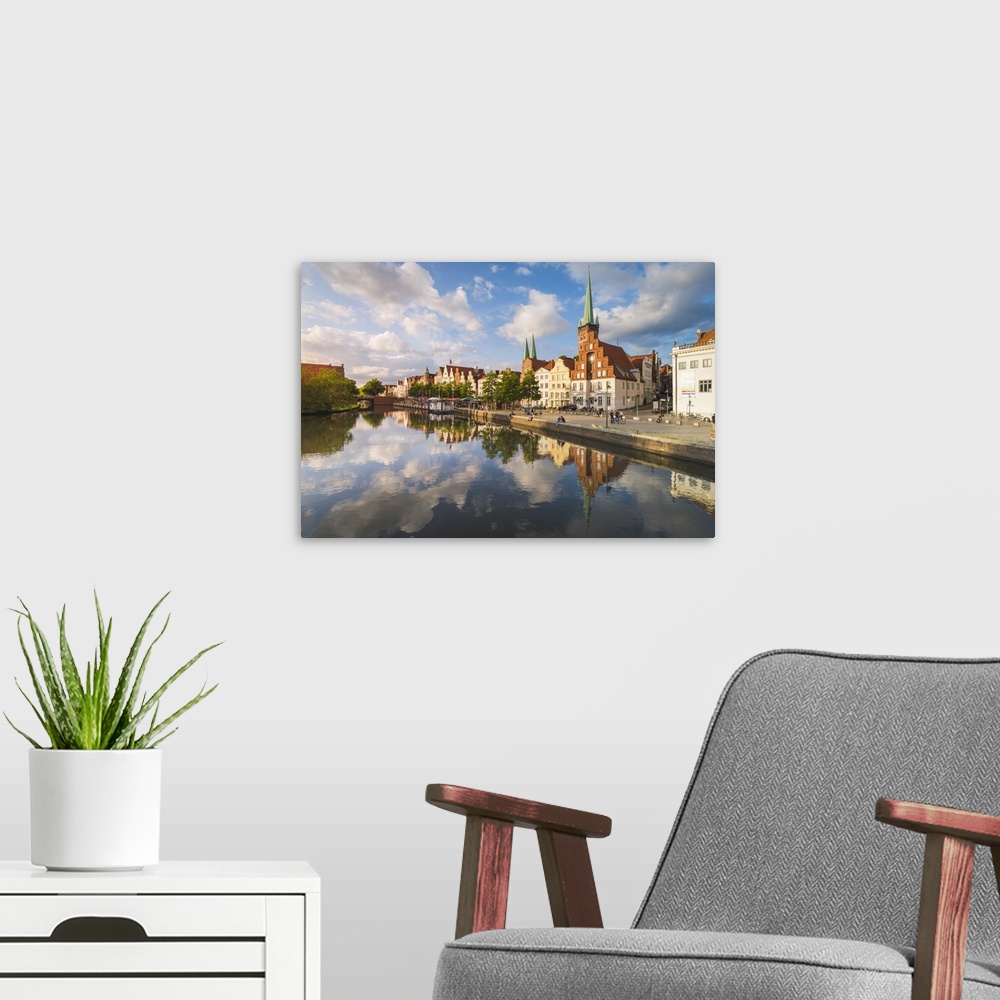 A modern room featuring Lubeck, Baltic coast, Schleswig-Holstein, Germany. Old town's houses along the Trave river's wate...