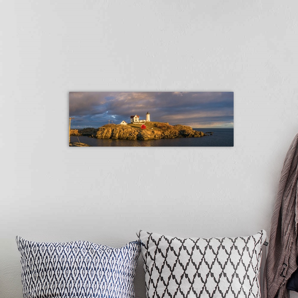 A bohemian room featuring USA, Maine, York Beach, Nubble Light Lighthouse with Christmas decorations, sunset.