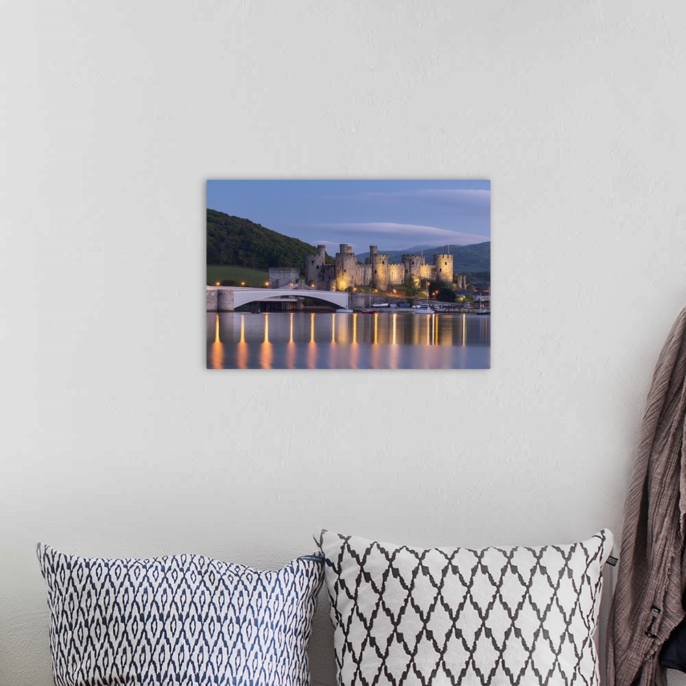 A bohemian room featuring Majestic ruins of Conwy Castle in evening light, Snowdonia National Park, Wales, UK. Spring