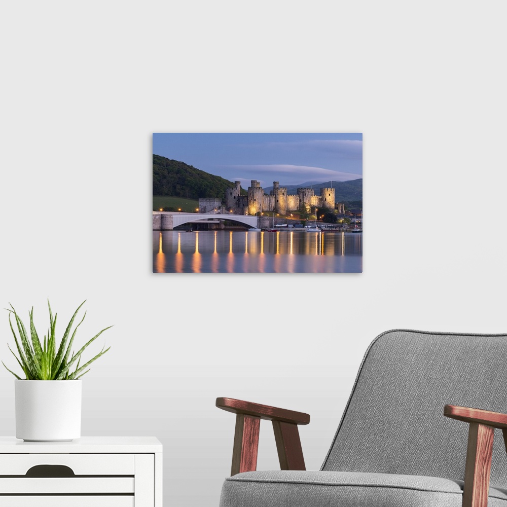 A modern room featuring Majestic ruins of Conwy Castle in evening light, Snowdonia National Park, Wales, UK. Spring