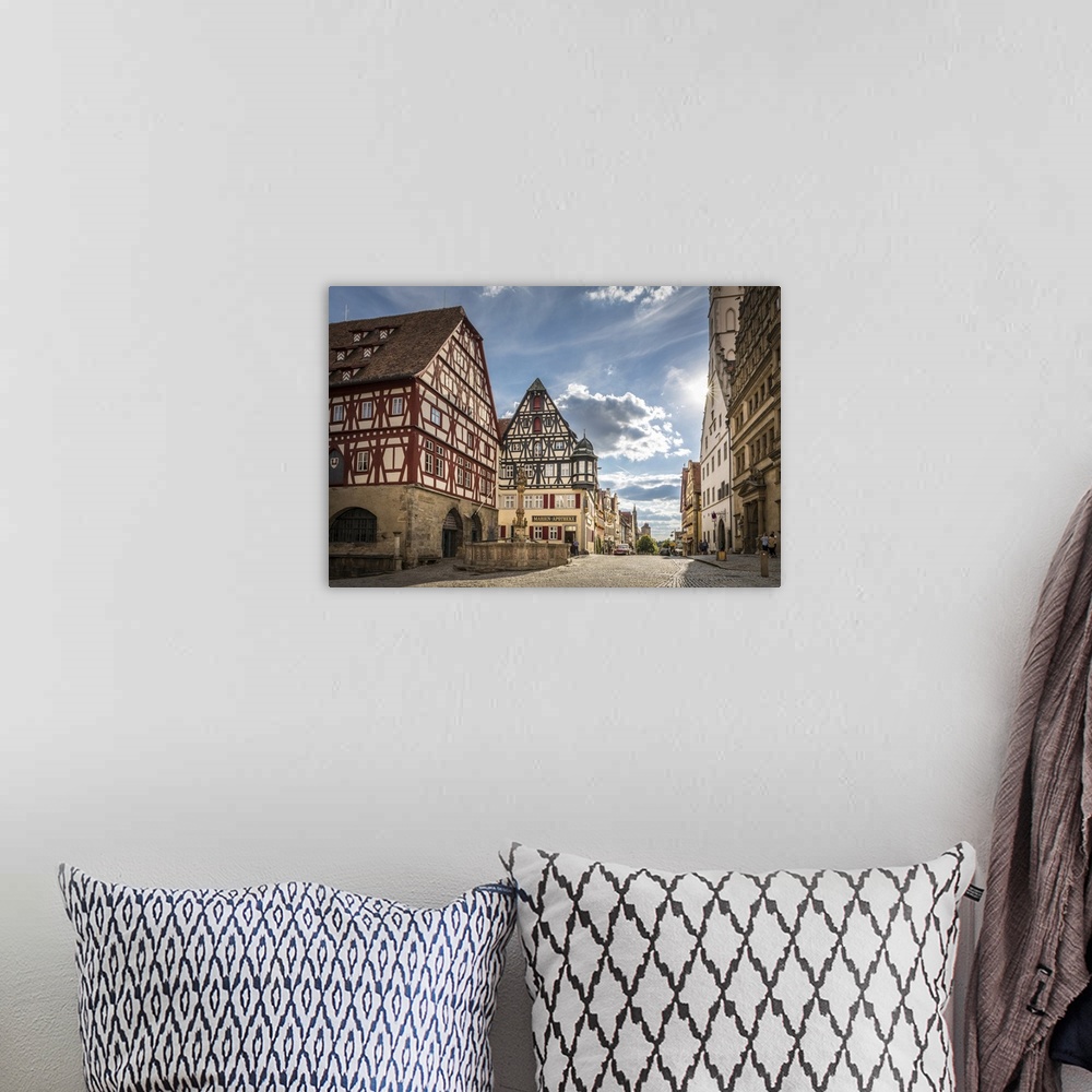 A bohemian room featuring Market Square fountain and historic houses in Herrngasse in the old town of Rothenburg ob der Tau...