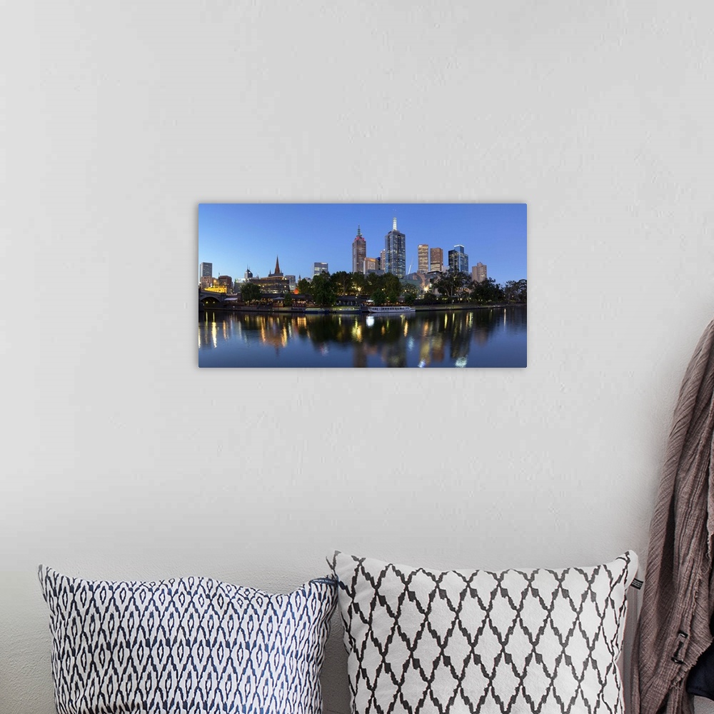 A bohemian room featuring Melbourne skyline along Yarra River at dusk, Melbourne, Victoria, Australia.