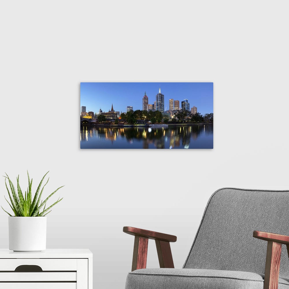 A modern room featuring Melbourne skyline along Yarra River at dusk, Melbourne, Victoria, Australia.