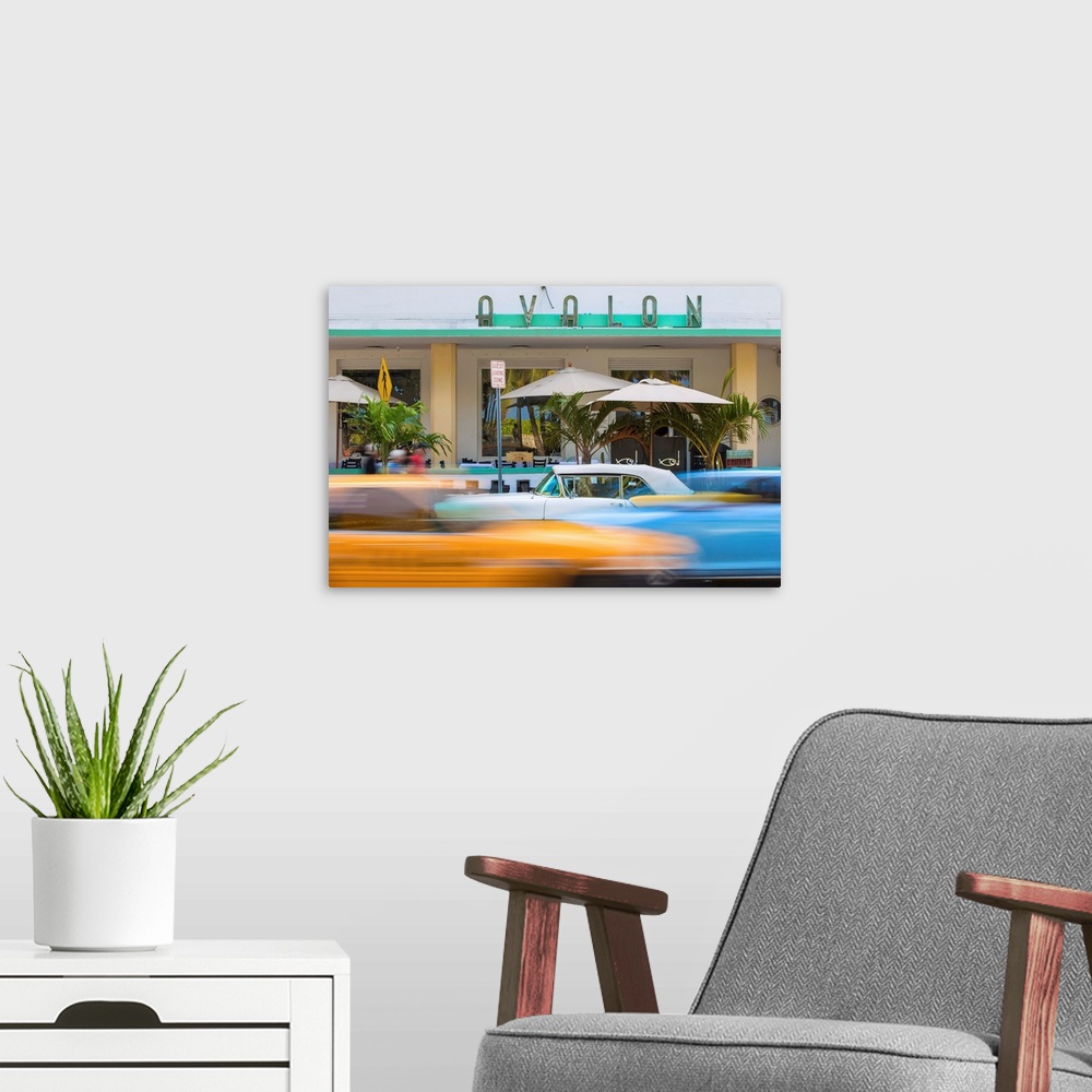 A modern room featuring U. S. A, Miami, Miami Beach, South Beach, Ocean Drive, Traffic passing Yellow and white vintage c...