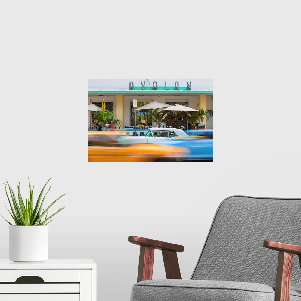 A modern room featuring U. S. A, Miami, Miami Beach, South Beach, Ocean Drive, Traffic passing Yellow and white vintage c...