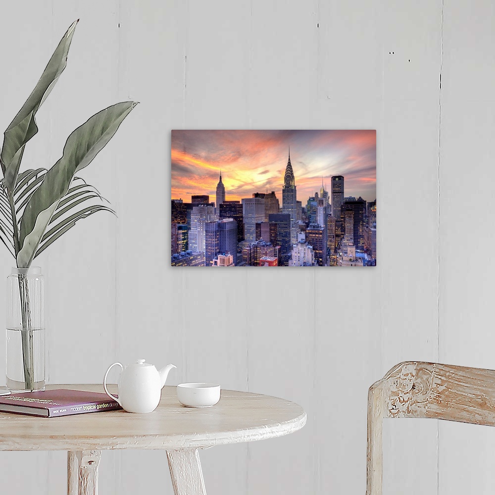 A farmhouse room featuring Some of the large skyscrapers in Manhattan are pictured under a beautiful sunset sky.