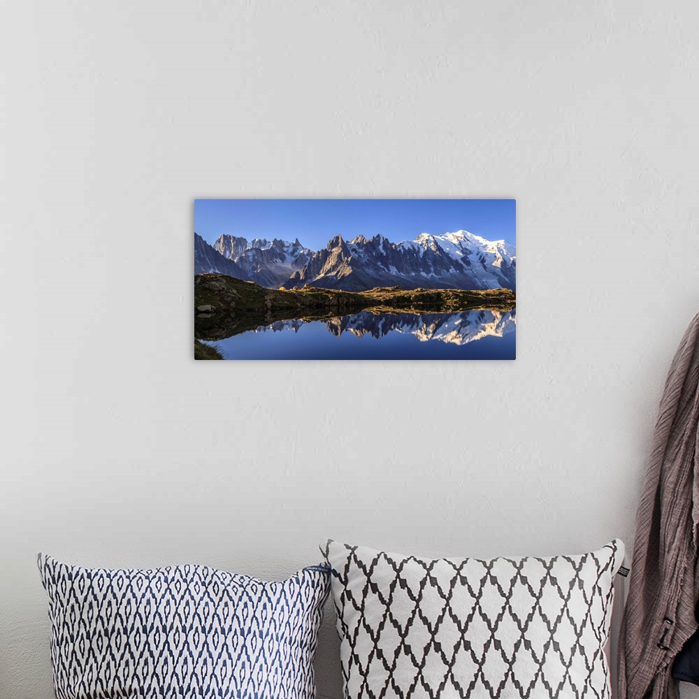 A bohemian room featuring The Mont Blanc mountain range reflected in the waters of Lac de Chesery at sunrise. Haute Savoie ...