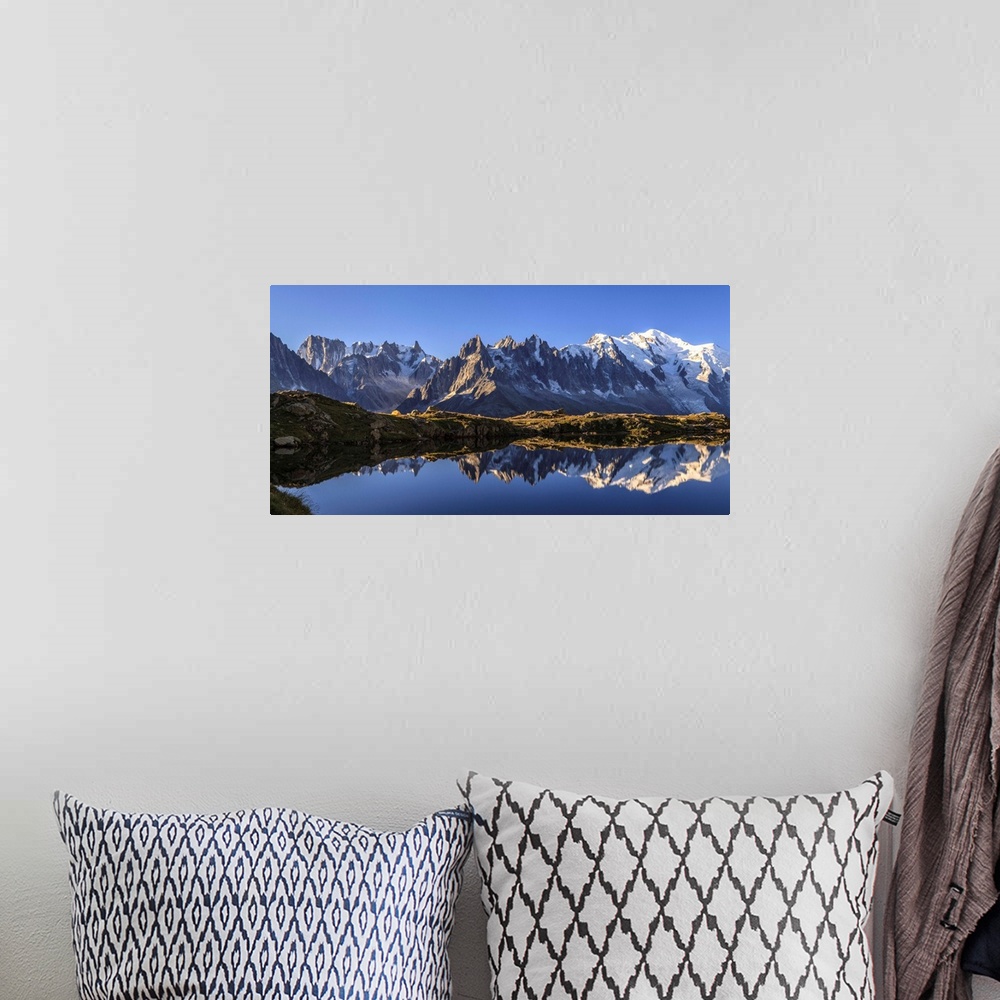 A bohemian room featuring The Mont Blanc mountain range reflected in the waters of Lac de Chesery at sunrise. Haute Savoie ...