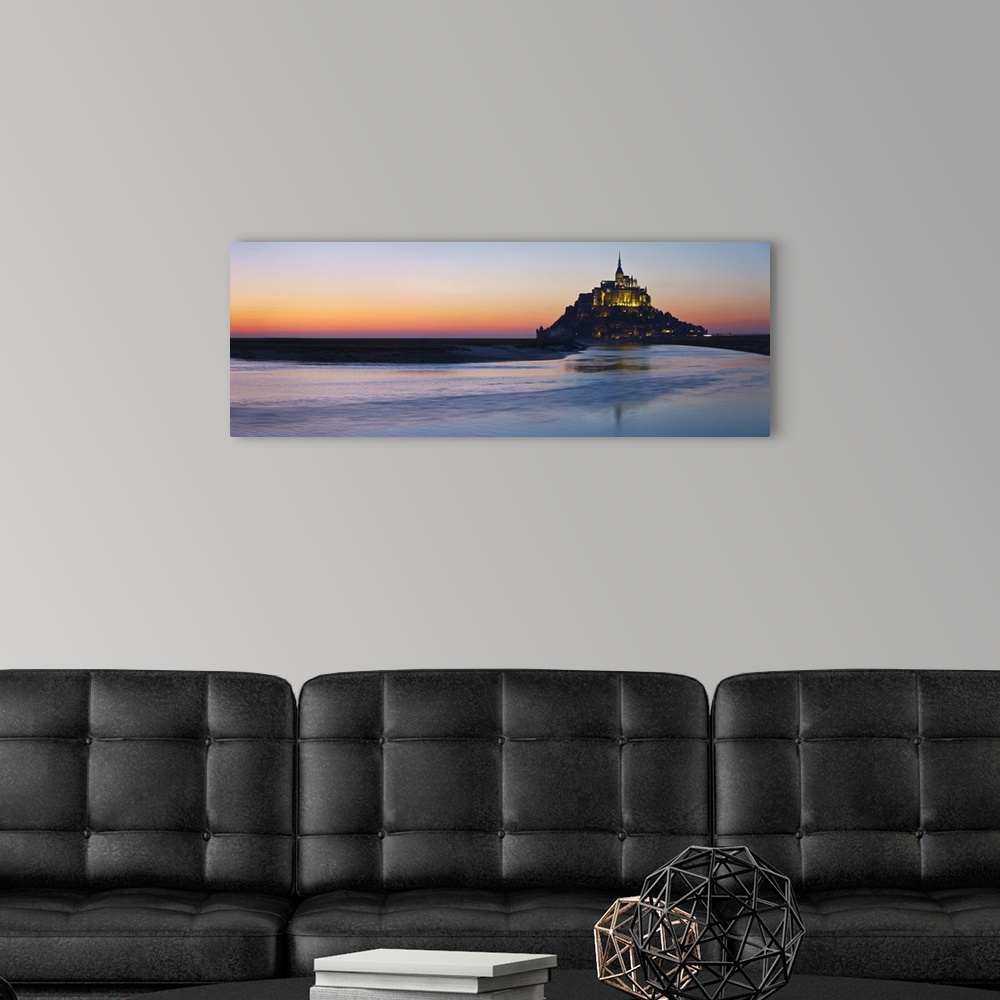 A modern room featuring Mont Saint Michel and its connection to the mainland via a tidal causeway with the River Couesnon...
