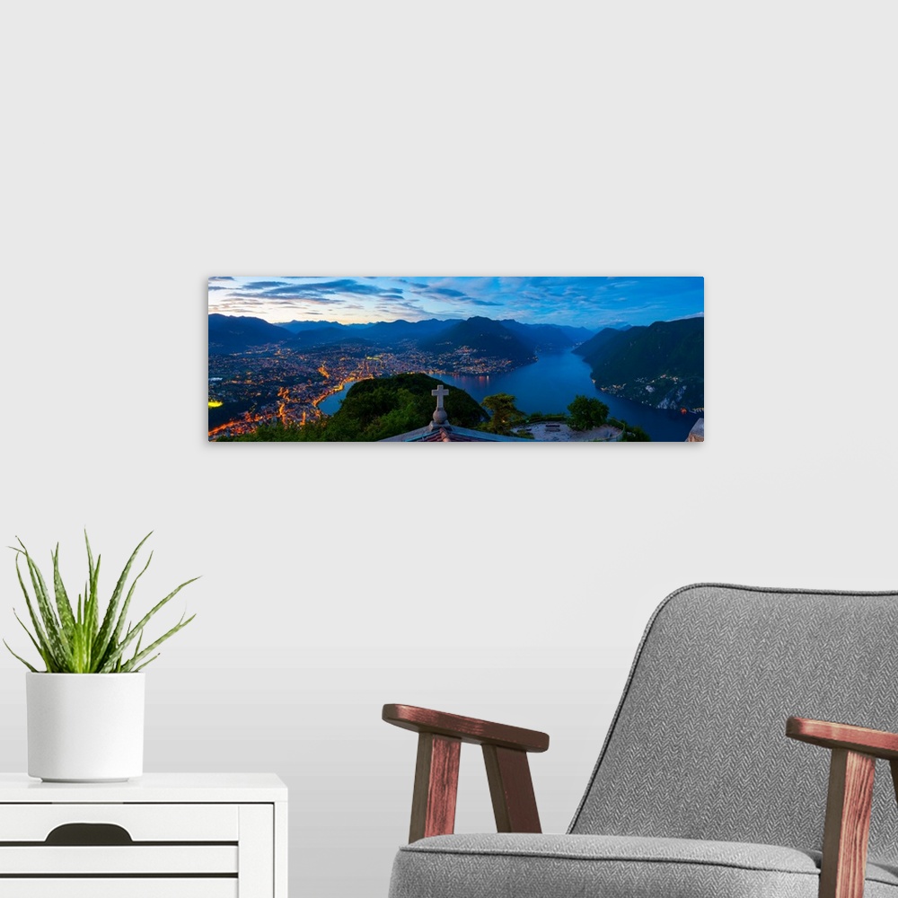 A modern room featuring Elevated view over Lugano from Monte San Salvatore illuminated at Dusk, Lake Lugano, Ticino, Swit...