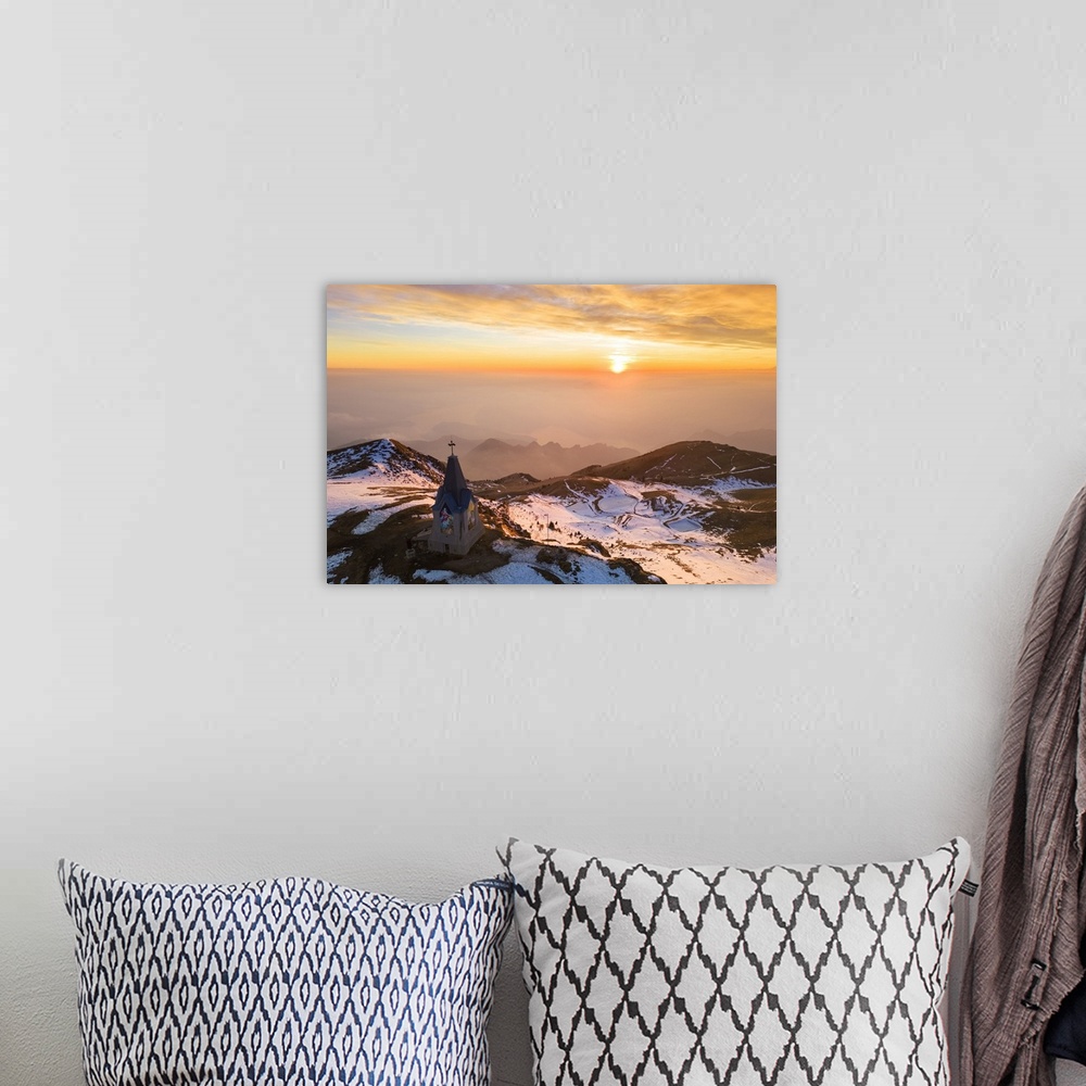 A bohemian room featuring Aerial view of a winter sunset over Monumento al Redentore chapel on the top of Mount Mount Gugli...