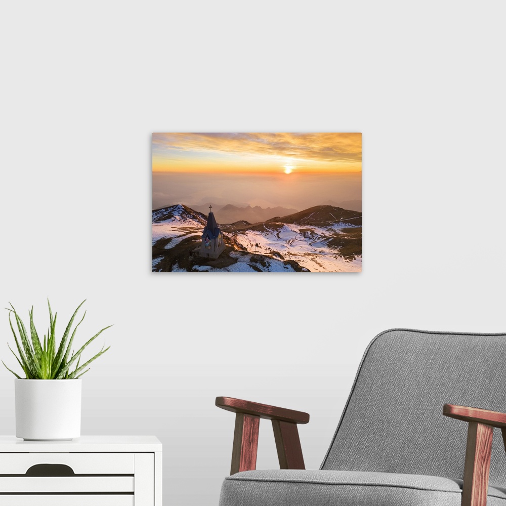 A modern room featuring Aerial view of a winter sunset over Monumento al Redentore chapel on the top of Mount Mount Gugli...