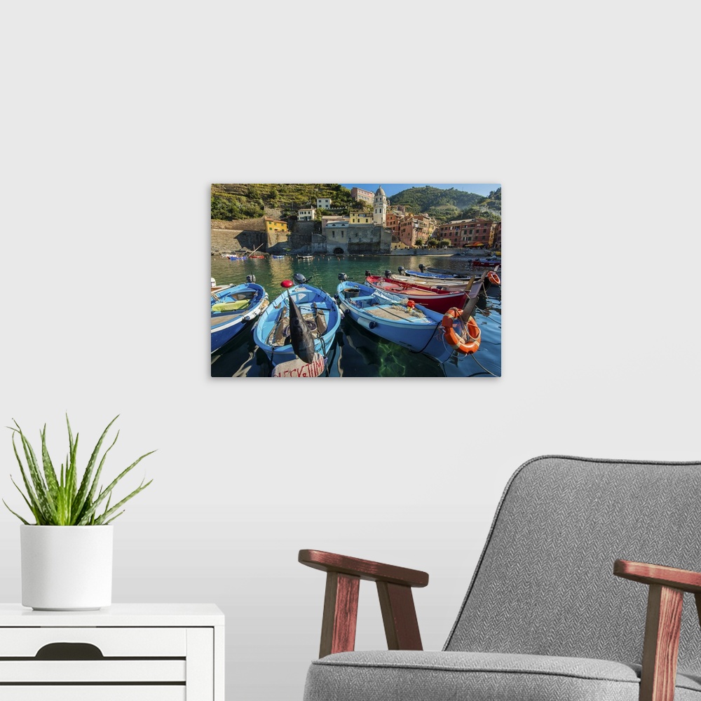 A modern room featuring Moored fishing boats in the small port of Vernazza, Cinque Terre, Liguria, Italy