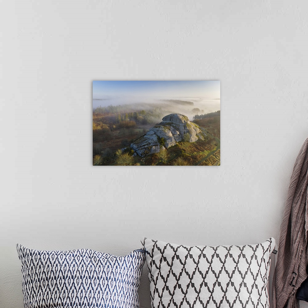A bohemian room featuring Morning mists swirl around Blackingstone Rock, a granite outcrop in Dartmoor National Park, Devon...