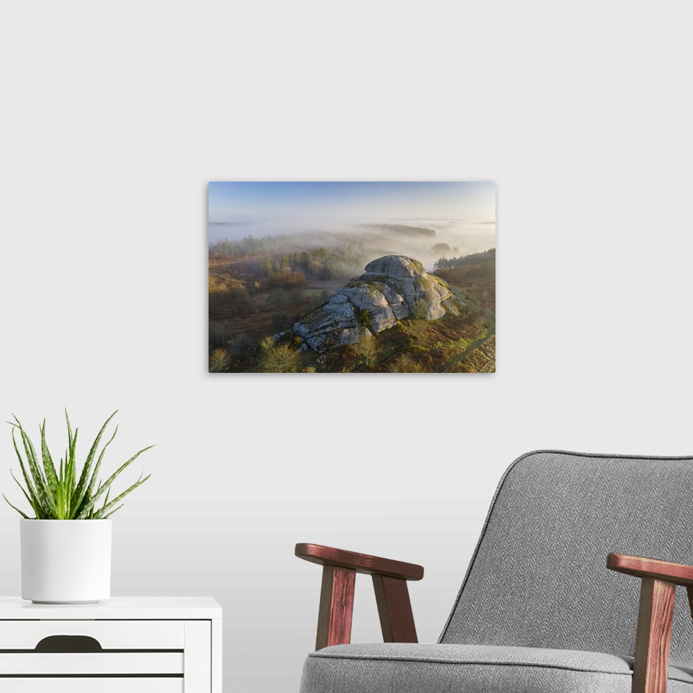 A modern room featuring Morning mists swirl around Blackingstone Rock, a granite outcrop in Dartmoor National Park, Devon...