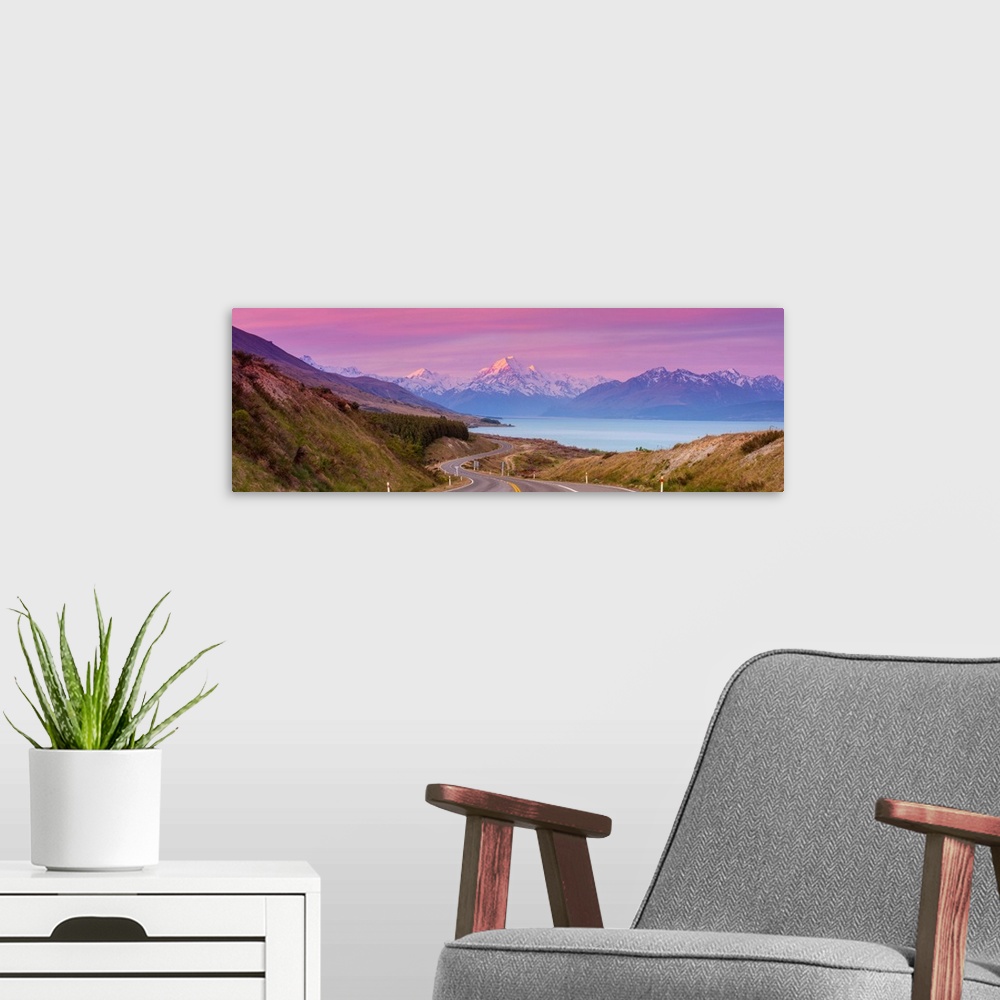 A modern room featuring Mount Cook (Aoraki) illuminated at sunset, Lake Pukaki, Mackenzie Country, Canterbury, South Isla...