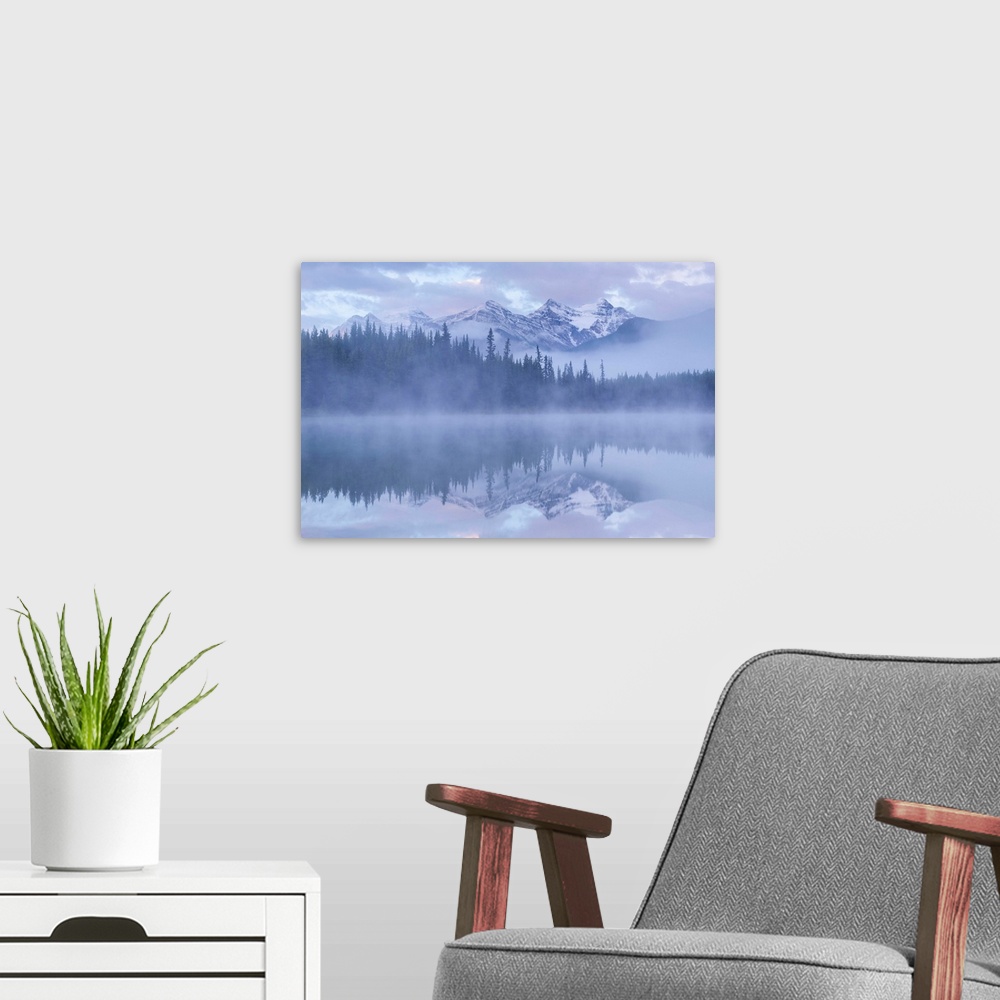 A modern room featuring Snow capped mountains reflect in a misty Herbert Lake, Canadian Rockies, Banff National Park, Alb...