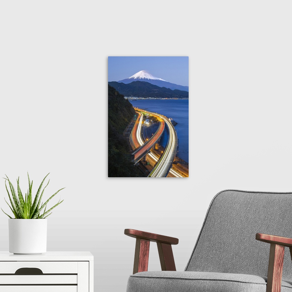 A modern room featuring Mt. Fuji and traffic driving on the Tomei Expressway, Shizuoka, Honshu, Japan
