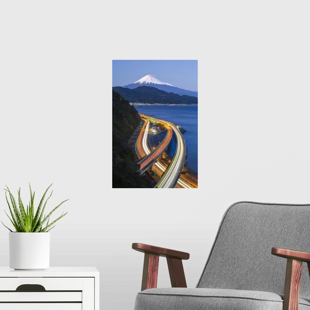 A modern room featuring Mt. Fuji and traffic driving on the Tomei Expressway, Shizuoka, Honshu, Japan
