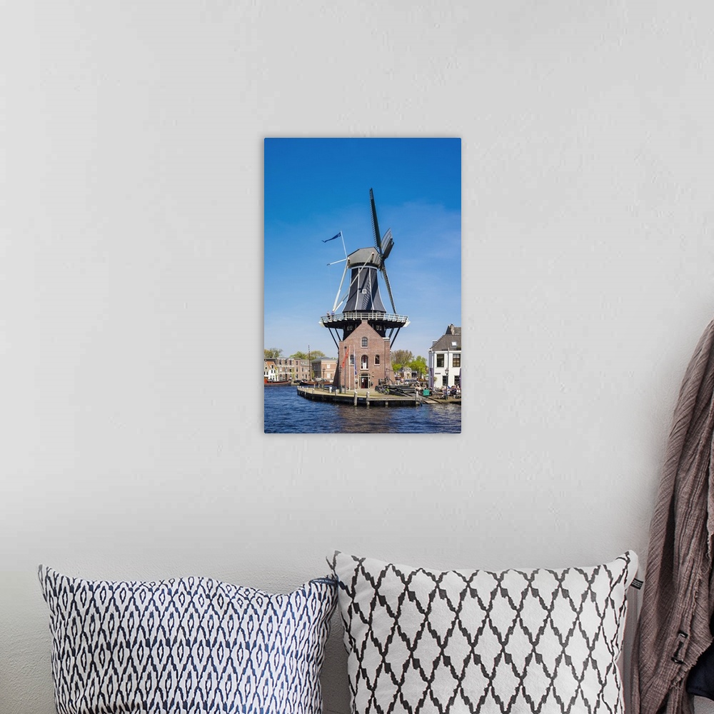 A bohemian room featuring Netherlands, North Holland, Haarlem. Windmill De Adriaan on the Spaarne River.