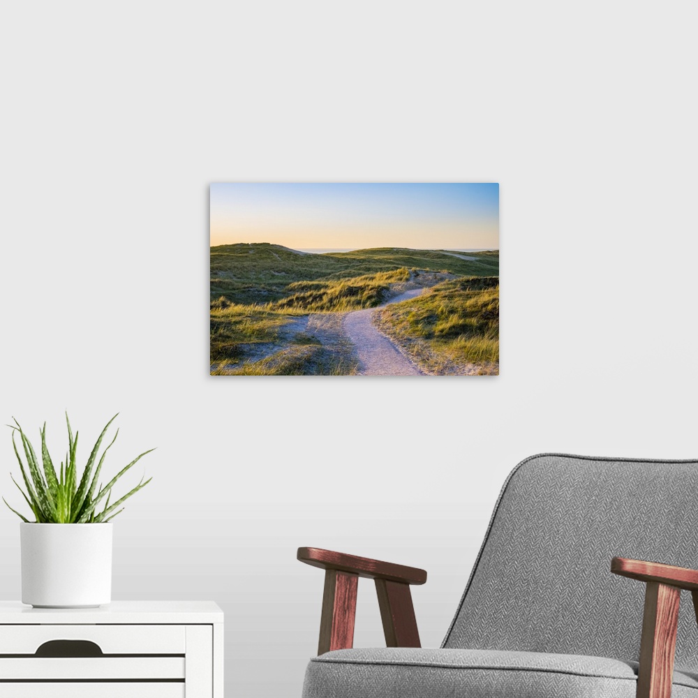 A modern room featuring Netherlands, North Holland, Julianadorp. Walking path through the dunes at sunset.